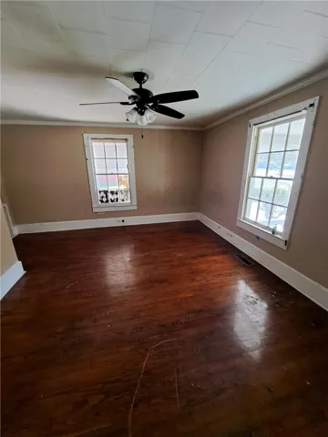 Warm wood flooring and classic sash windows define this versatile interior space.