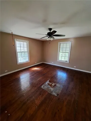 Original hardwood flooring and classic multi-pane windows anchor this spacious room.