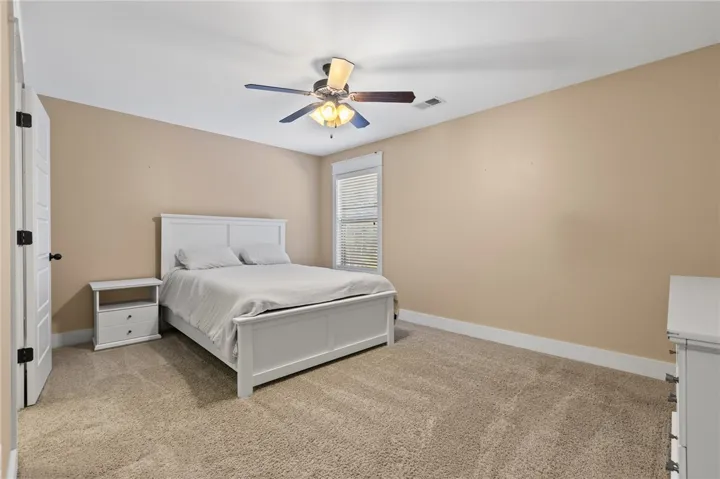 Soft carpeting pairs with a classic window frame to create a peaceful, inviting atmosphere.