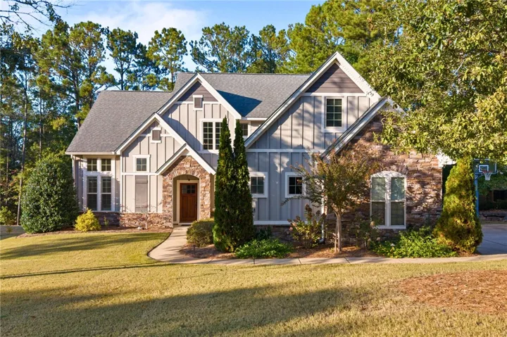 Board and batten siding pairs with natural stone accenting the front facade.