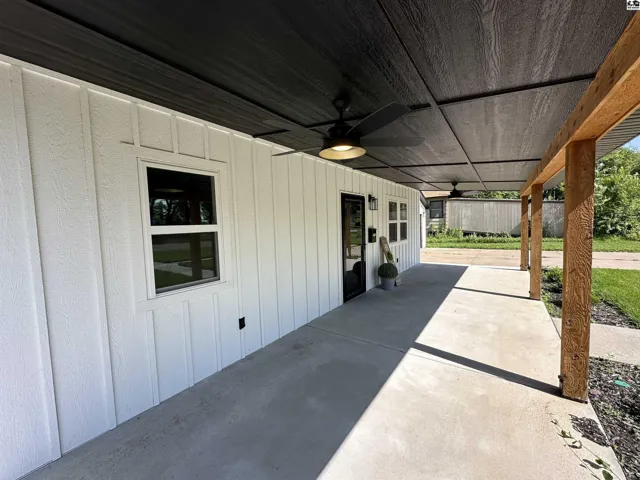 Gorgeous covered front porch with double fans and recessed lighting.