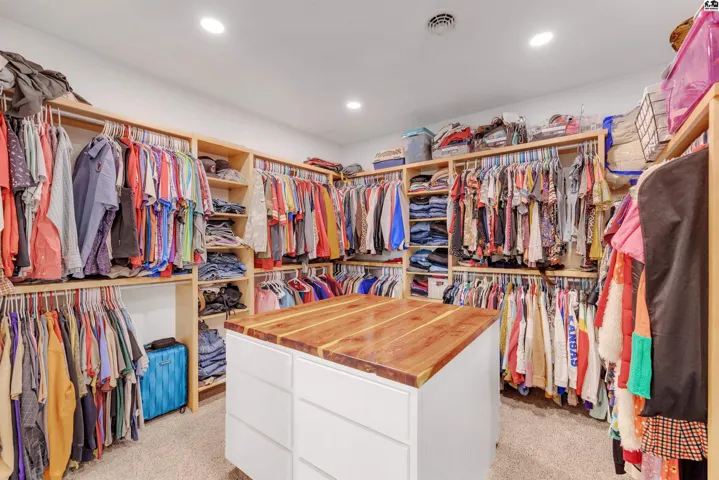 Master Closet with built in dressers drawers on both sides of center island