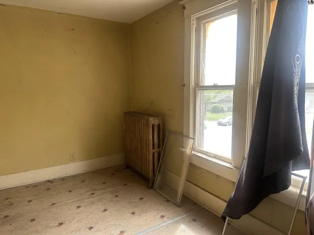 offers kitchenette sink and cabinetry in corner and an adjacent 3/4 bath with stand up shower