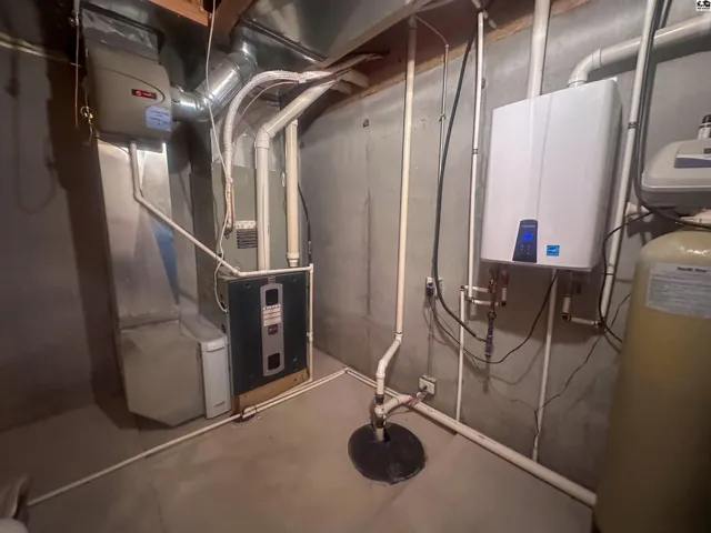Basement utility room with view of HVAC system  and tankless water heater.