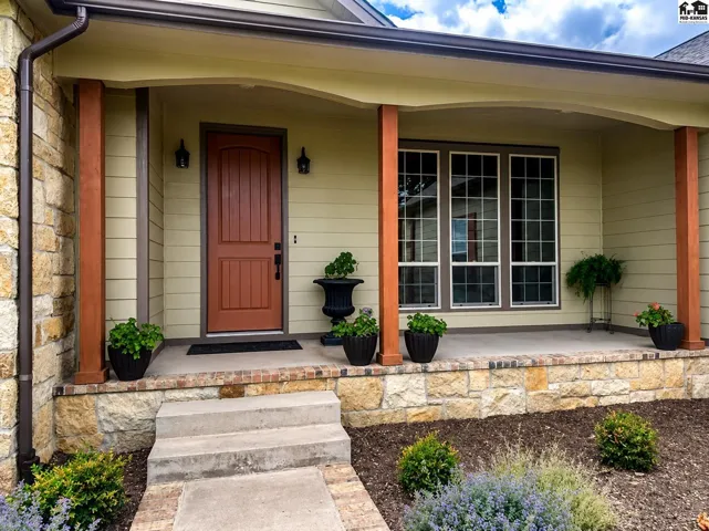Texas Limestone, brick, concrete siding & cedar posts. Circle drive with Limestone pillars at end.