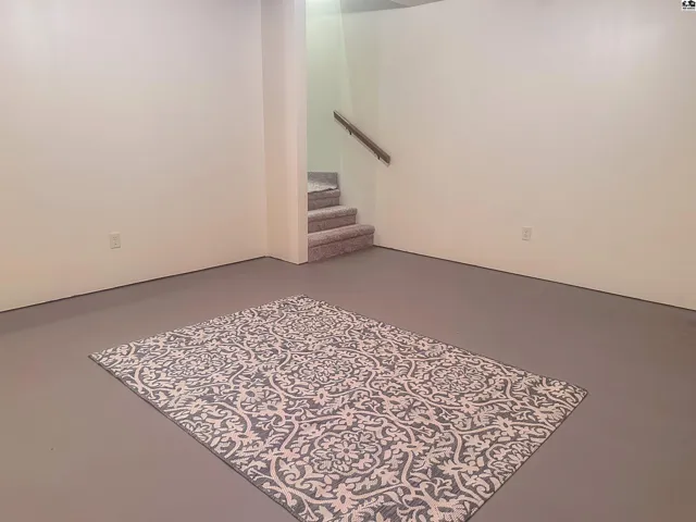 Basement family room or bonus room with view of stairway.