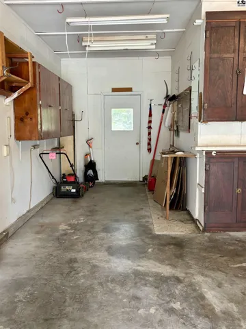 Workshop space at the back of the garage with door to the back yard.