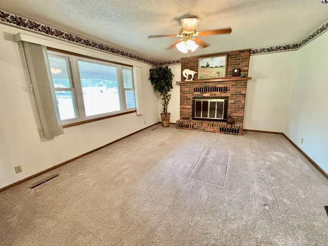 Classic wall of windows and a wood burning fireplace are a great welcoming combination.