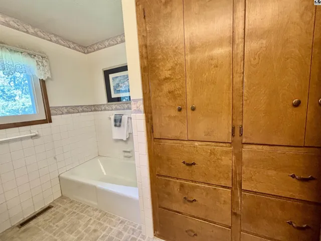Check out the storage in this hall bathroom!