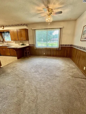 Open space for dining room table, built-in hutch, and counter top seating.