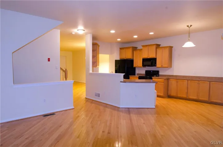 View from Family Room into Kitchen with Tons of Cabinetry
