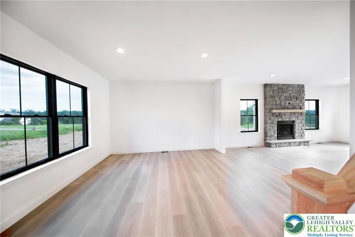 Double black Pella windows bring a ton of light. Scenic views out every window! Large quartz center island with a lots of cabinets.