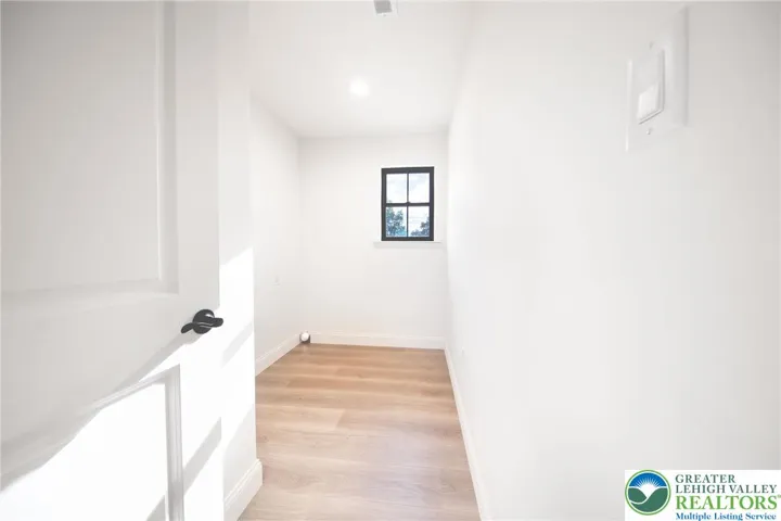 Laundry room on third floor with closet