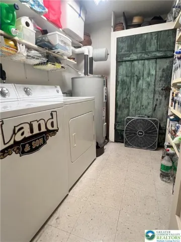 ample laundry room with pantry shelving.