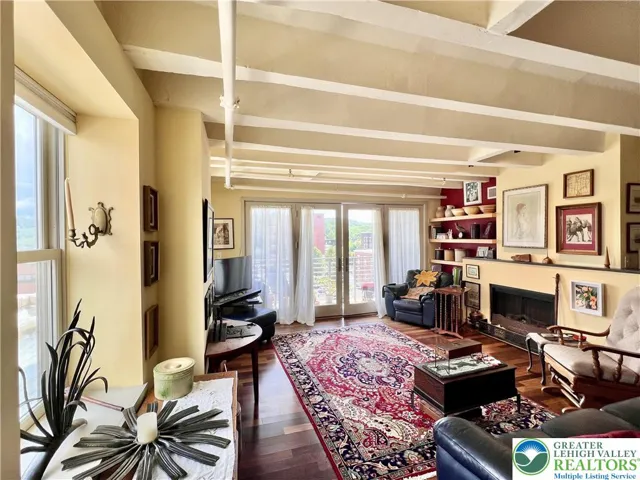 Living room features a glowing electric fireplace with cozy heatilator.