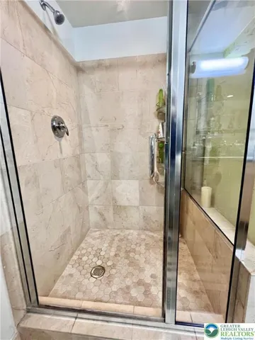 Primary bedroom shower is beautifully tiled as well as the second full bath shower.