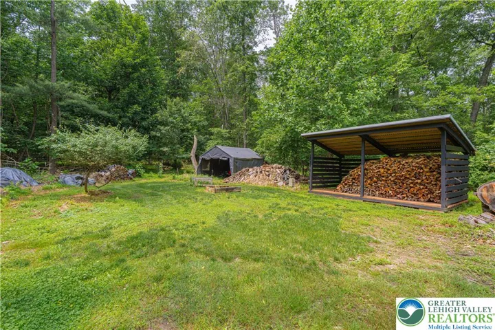 Wood shed and storage area for lawn mower