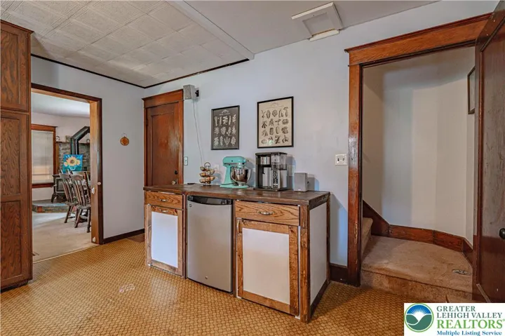 Kitchen area with wine fridge and storage