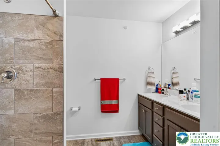 Primary Bathroom w/ dual vanity and walk in shower