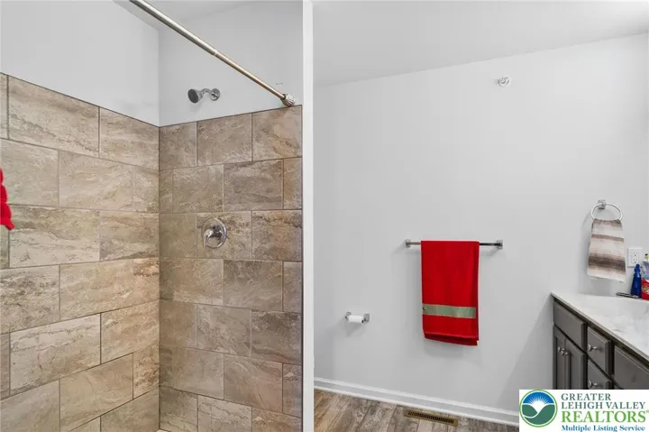 Primary Bathroom w/ dual vanity and walk in shower