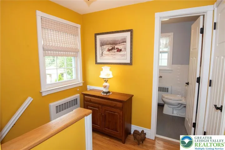 At the top of stairs, updated hall bath at right.