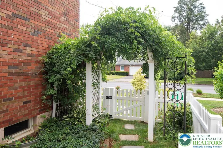 This flowering vine covered gate is on the left side of the house.
