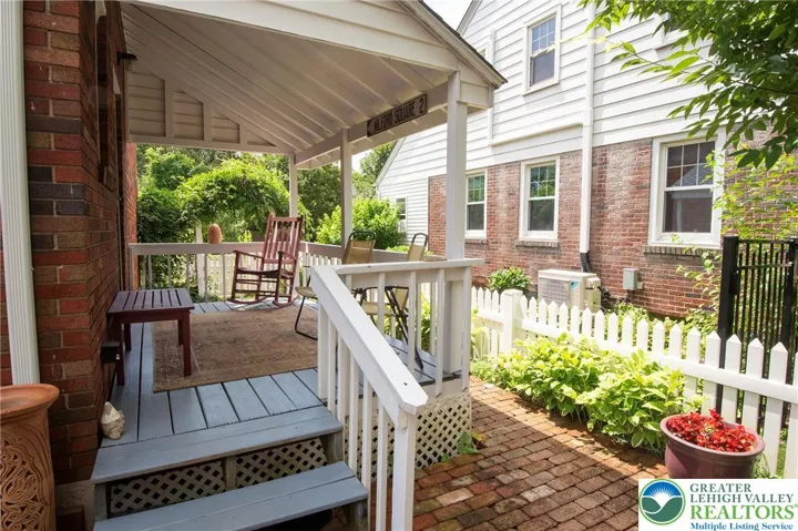 Covered back porch. Brick patio extends to walkway around the porch.