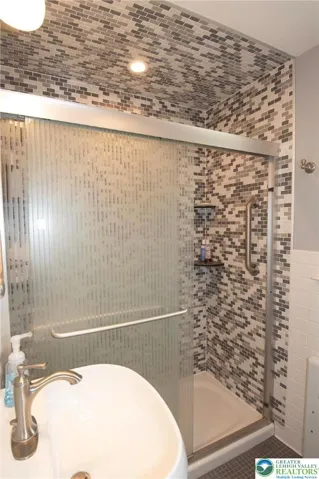 This updated main bath has a beautiful large shower.