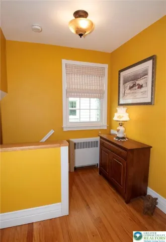Top of stairs landing has room for a piece of furniture.