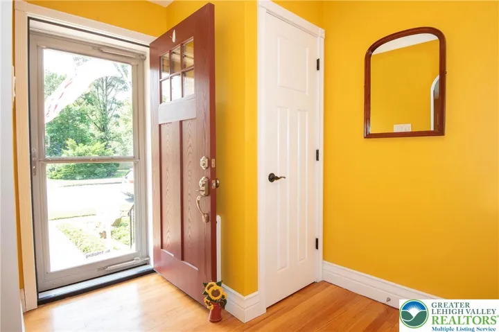 But let's take a look inside first: WELCOME! Coat closet in foyer. Beautifully refinished hardwood floors. "Colonial Gold" walls add warmth and a color pop.