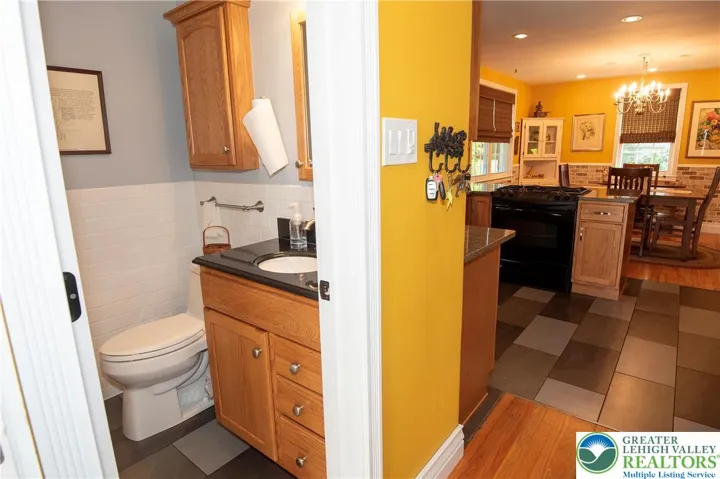 Updated first floor powder conveniently tucked behind kitchen and near back door.