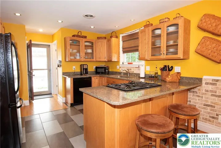 Heart of the Home.  Updated kitchen w/granite counters, GE Profile appliances, breakfast bar, handsome tile floor.
