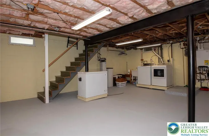 Let's pop down to the basement. Clean and dry with great storage options. Water softener (owned) behind stairs, washer & dryer remain, hot water on demand unit on wall .