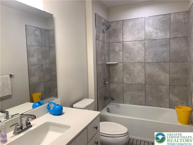 Family bath with tiled shower walls