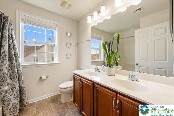 Hallway bathroom with double sinks