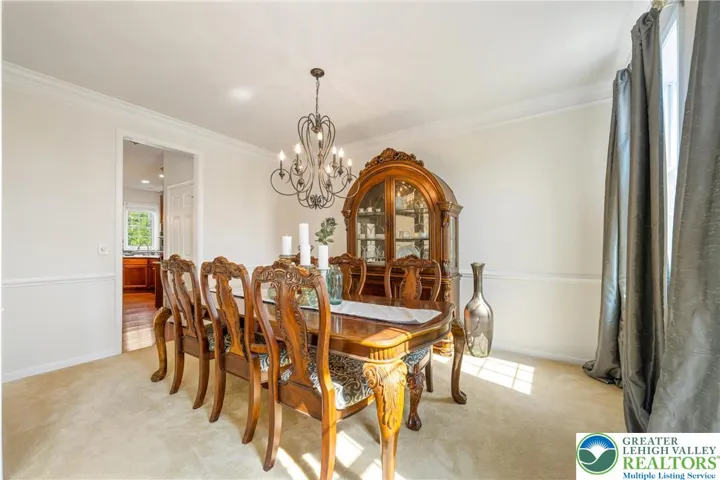 Dining room with crown molding and wainscoting