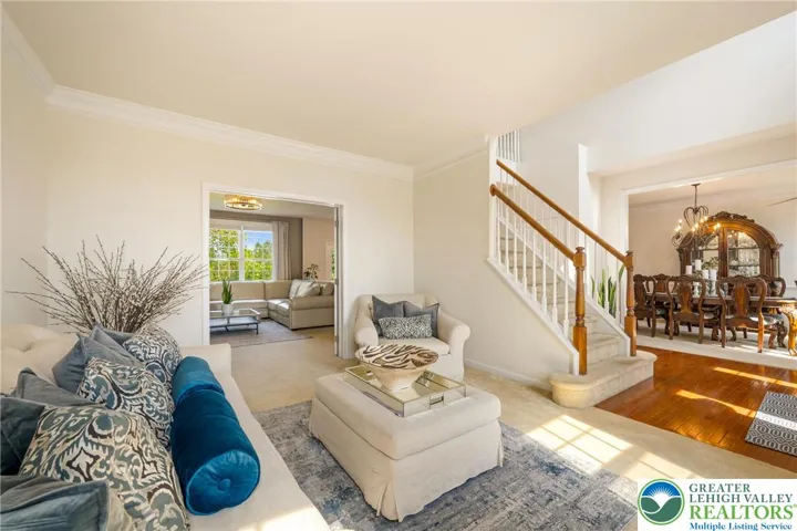 Living room adjacent to family room with double door entry