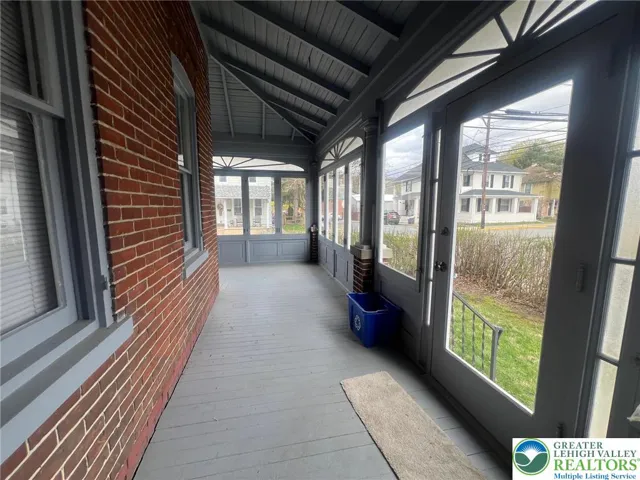 Shared sunroom entrance into 1st floor apartment