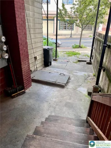 cute patio area by the sidewalk leads to your door.