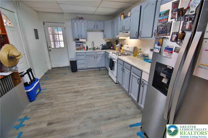 Kitchen features painted cabinets, refreshed countertops and new SS refrigerator