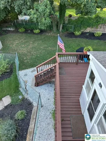 Deck overlooking fenced yard