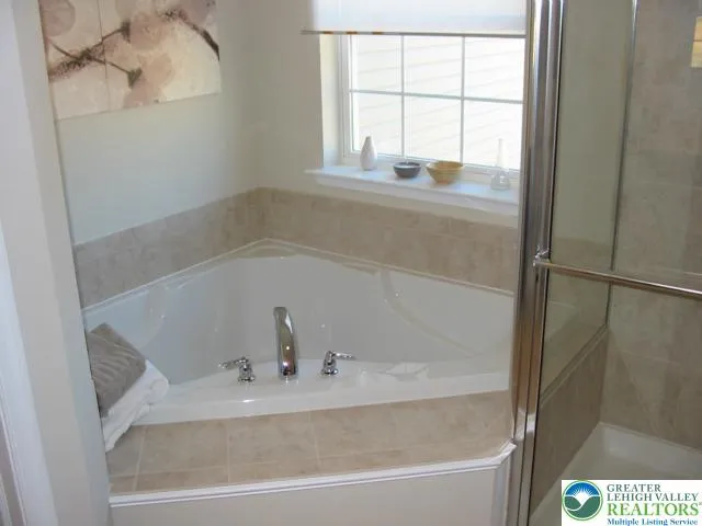 Salon style master bathroom with luxurious corner soaking tub, ceramic tiled floors, ceramic shower walls and tub surround.  Why not spoil yourself without paying extra.