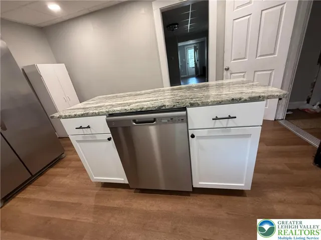 New island with granite and dishwasher.