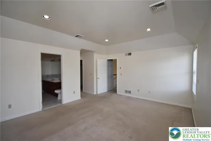 Primary Bedroom with hallway to walk-in closet and sitting room to the right of the bathroom