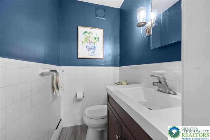 half-bath with bold blue accents.