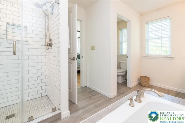 Primary bath with private water closet and tiled walk-in shower