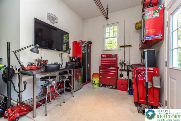 Currently storage area used as a workshop. All of the cabinets/workbench/equipment do not remain