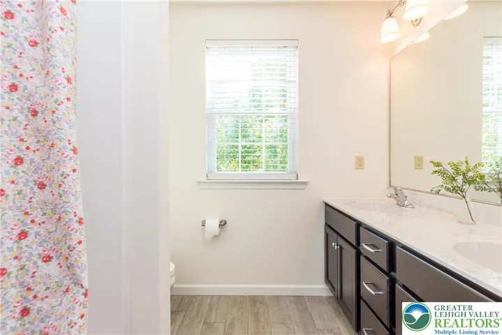 Second floor hall bath with tub/shower combo and double vanity