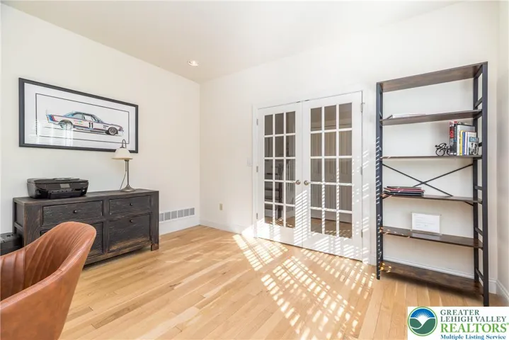 Home office with recessed lights and hardwood floors