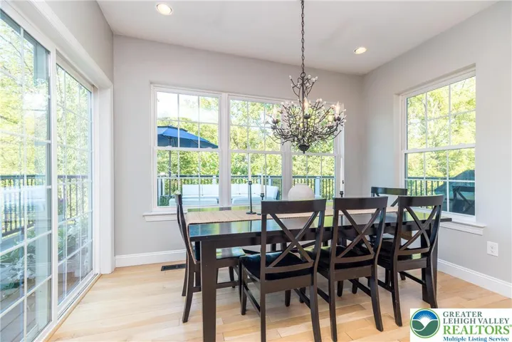 The kitchen opens to the breakfast area. Sliding door leads to the composite deck